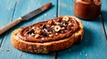Delicious hazelnut chocolate spread on toasted bread with crunchy nuts and chocolate pieces Royalty Free Stock Photo