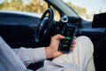 Close up view of smartphone in man hands that is showing electric car charging progress Royalty Free Stock Photo