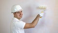 Close up view of smiling man holding paint roller Royalty Free Stock Photo