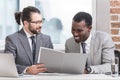 close up view of smiling multiethnic business partners reading document