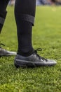 Close up view of a soccer football player`s legs and cleats Royalty Free Stock Photo