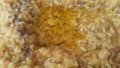 A close up view spicy daal dish served with ghee on it