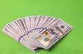 Close up view of spread out stack of dollars isolated on green background Royalty Free Stock Photo