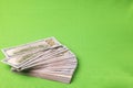 Close up view of spread out stack of dollars isolated on green background. Royalty Free Stock Photo