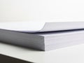 Close up view of stack of blank white paper sheets on a white surface Royalty Free Stock Photo