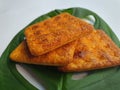 Close up view of a stack of crackers biscuit on an ornamental green monstera leaf. Royalty Free Stock Photo