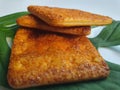 Close up view of a stack of crackers biscuit on an ornamental green monstera leaf.