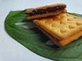 Close up view of a stack of crackers biscuit on an ornamental green monstera leaf. Royalty Free Stock Photo