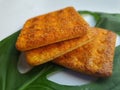 Close up view of a stack of crackers biscuit on an ornamental green monstera leaf.