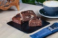 Close up view on stack of homemade brownies with coffee. Royalty Free Stock Photo