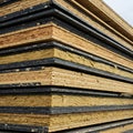 A close-up view of a stack of layered building panels with insulation, showing the composition of modern construction materials. Royalty Free Stock Photo