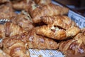 Close-up view of a stack of mini croissants placed in a wooden serving tray
