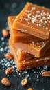 A close-up view of a stack of pieces of food, showcasing caramel-coated peanuts in a delicious and tempting arrangement