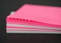 Stack of bright pink and white paper sheets with serrated edge isolated on white background Royalty Free Stock Photo