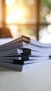 Close up view of a stack of white paper documents held together with binder clips on a table Royalty Free Stock Photo