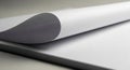 A close-up view of a stack of white paper with a single sheet partially curled over. The Royalty Free Stock Photo