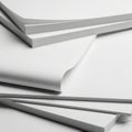 A close-up view of a stack of white papers with a torn edge revealing a gray background Royalty Free Stock Photo