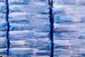 Close up view of a stacks of blue bales with sawdust on a farm