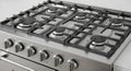 Close up view of a stainless steel gas range cooktop with multiple burners and control knobs Royalty Free Stock Photo