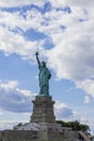 Close-up view of Statue of Liberty on Liberty Island in New York against blue sky with white clouds. Royalty Free Stock Photo