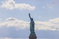 Close-up view of Statue of Liberty on Liberty Island in New York against blue sky with white clouds. Royalty Free Stock Photo