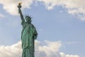 Close up view of Statue of Liberty on Liberty island in New York isolated on blue sky with clouds. Royalty Free Stock Photo