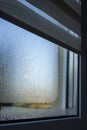 Close-up view of steamy condensate on a leaky window in a house. Royalty Free Stock Photo