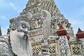 Close-Up View of Stone Chinese Guardian with Stupa of Wat Arun Ratchawararam Royalty Free Stock Photo