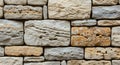A close-up view of a stone wall composed of irregular, rectangular sandstone blocks in varying Royalty Free Stock Photo