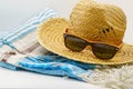 Close-up view of a straw hat, suntan lotion, beach towel and sunglasses. Summer vacations, sun protection and sun safety Royalty Free Stock Photo