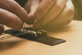 Close up view on string changing process on acoustic guitar Royalty Free Stock Photo