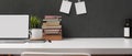 Study table with mock up laptop, stack of books, notepad, decorations and copy space on white table Royalty Free Stock Photo