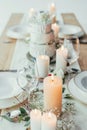 close up view of stylish table setting with candles, empty wineglasses and plates