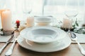 close up view of stylish table setting with candles, empty wineglasses and plates