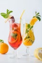 close up view of summer fresh cocktails with strawberry, lemon and orange pieces, mint