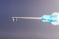 Close up view of a syringe with hypodermic needle and a droplet of fluid. Opiate and heroin overdoses have skyrocketed II Royalty Free Stock Photo