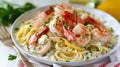 A close-up view of tagliatelle pasta coated in a rich, creamy sauce with succulent shrimp garnished with parsley, on a