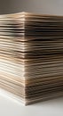 A close-up view of a tall stack of neatly arranged paper sheets on a flat surface. The Royalty Free Stock Photo