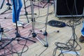 Close up view of tangled black wires and cables plugged and microphone stand on the ground, chaos after concert Royalty Free Stock Photo