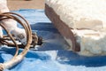 Close up view of technician dressed in a protective white uniform spraying foam insulation using Plural Component Spray Gun.