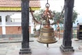 Close up view of a temple bell made up of bronze material, hanged in between two pillars Royalty Free Stock Photo