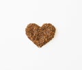Close-up view of texture of rooibos tea leaves stuffed into heart shape isolated