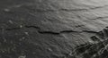 Close-up view of a textured black slate surface, illustrating the layered, rough texture typical of Royalty Free Stock Photo