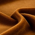 Close-up view of textured brown fleece fabric, showcasing its soft, smooth surface. Royalty Free Stock Photo