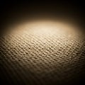 A close-up view of a textured burlap fabric displaying a distinct weave pattern. The Royalty Free Stock Photo