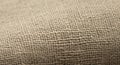 Close-up view of a textured burlap fabric, showcasing its coarse, woven pattern. The fabric appears Royalty Free Stock Photo