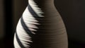 Ceramic vase partially illuminated by light creating distinct shadows Royalty Free Stock Photo