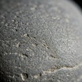 Close-up view of a textured grey stone surface. The image captures fine details, Royalty Free Stock Photo