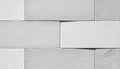 Close up view of textured light gray rectangular stacked stone wall cladding blocks showing Royalty Free Stock Photo