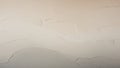 Textured off white plaster surface with subtle wavy organic lines and shadows creating a soft abstract background Royalty Free Stock Photo